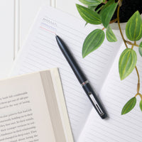 uniball™ JETSTREAM PRIME, 0.5mm Ballpoint Pen, Matte Metal Barrel, in use, journaling image, 352245001