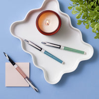 uniball™ AIR, 0.5mm Porous Point Pen,  Limited Edition Luxury Barrel Colors, pink, green and blue barrel colors together in use image