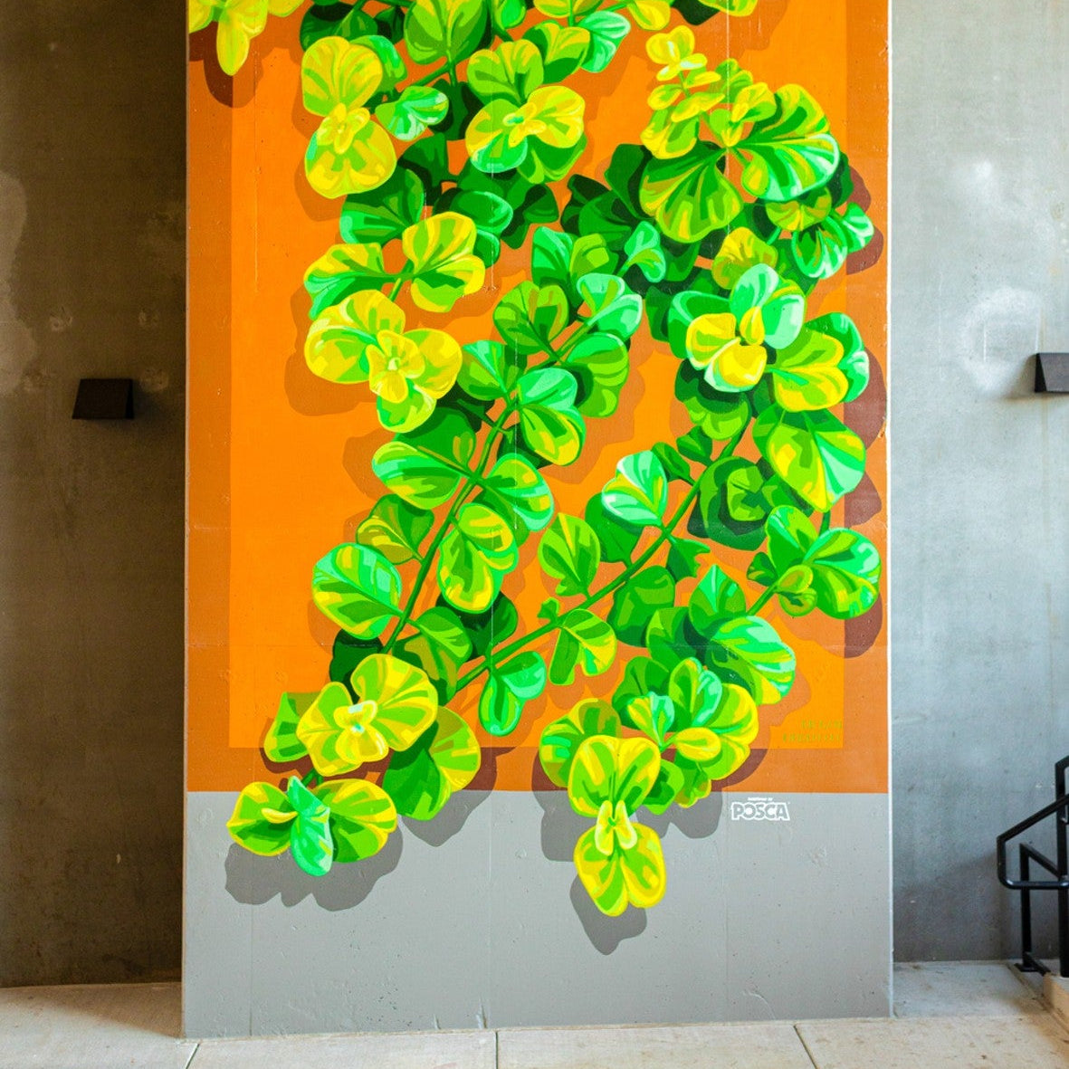 Artistic depiction of green leaves on an orange background